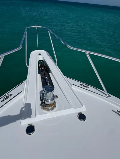  Yacht Photos Pics Bow of 2005 Hatteras 50 Convertible yacht on turquoise water.