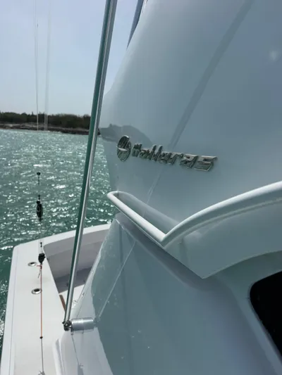  Yacht Photos Pics 2005 Hatteras 50 Convertible yacht on water, showcasing sleek design and logo.