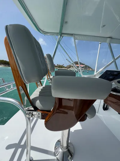  Yacht Photos Pics Captain's chair on 2005 Hatteras 50 Convertible yacht, overlooking turquoise waters.