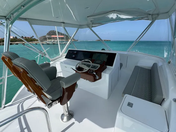  Yacht Photos Pics Helm of 2005 Hatteras 50 Convertible yacht with ocean view and luxury seating.