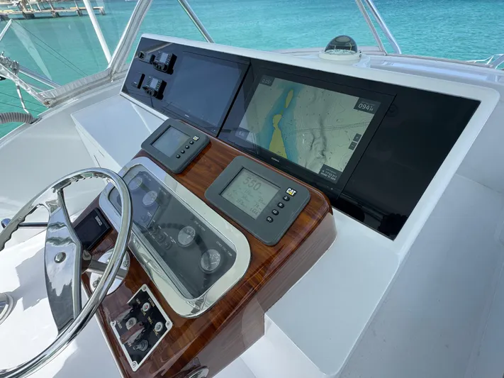  Yacht Photos Pics Helm of 2005 Hatteras 50 Convertible yacht with navigation screens and controls.