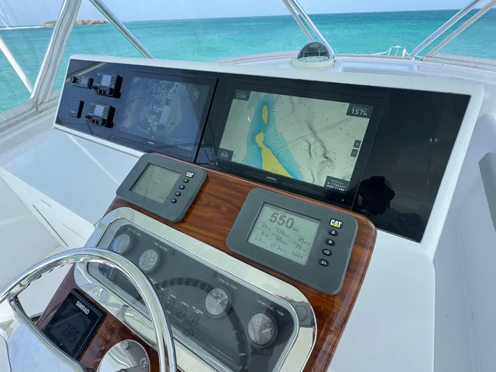  Yacht Photos Pics Helm of 2005 Hatteras 50 Convertible yacht with navigation displays and ocean view.