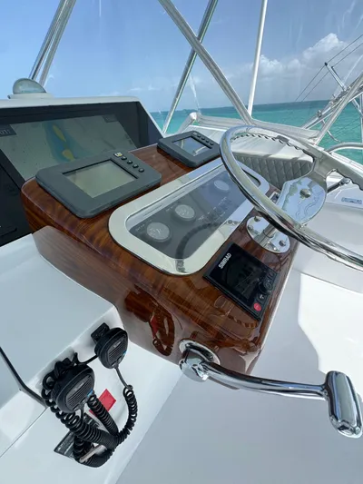  Yacht Photos Pics Helm of 2005 Hatteras 50 Convertible yacht with navigation instruments and ocean view.