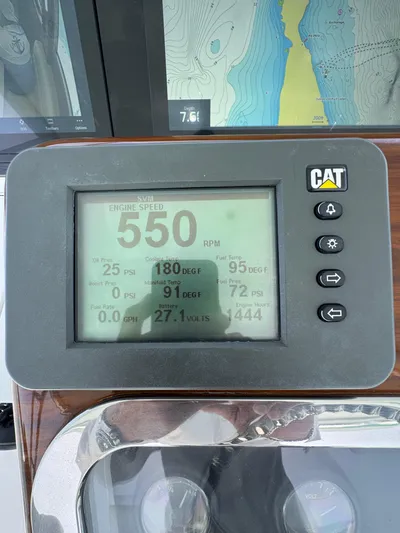  Yacht Photos Pics CAT engine display on 2005 Hatteras 50 Convertible boat, showing RPM and engine data.