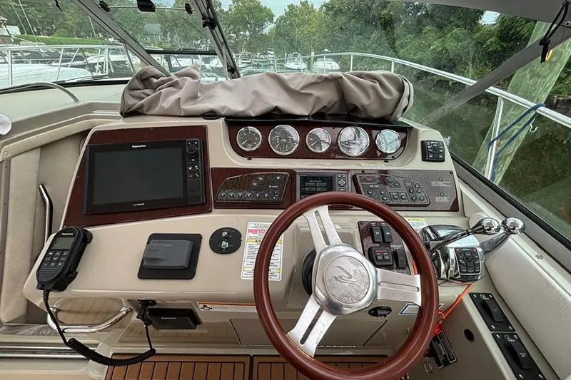  Yacht Photos Pics Helm of 2011 Sea Ray 370 Sundancer with steering wheel and navigation controls.