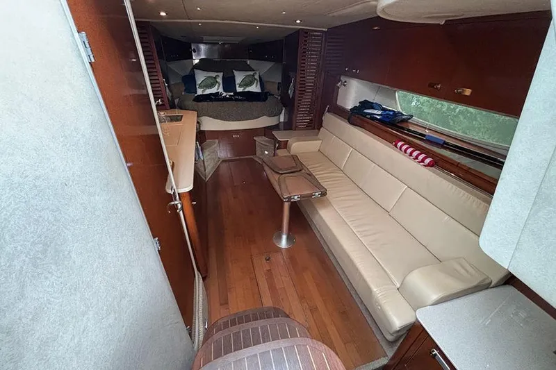  Yacht Photos Pics Luxurious interior of 2011 Sea Ray 370 Sundancer with leather seating and wooden flooring.