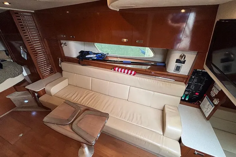  Yacht Photos Pics Luxurious interior of 2011 Sea Ray 370 Sundancer yacht with leather seating and wooden finishes.