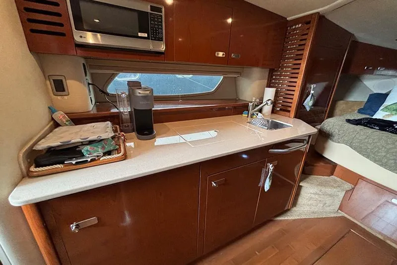 Yacht Photos Pics Interior of 2011 Sea Ray 370 Sundancer yacht with kitchenette and cozy cabin.