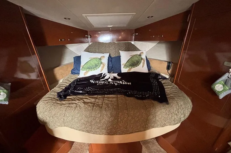  Yacht Photos Pics Cozy cabin interior of 2011 Sea Ray 370 Sundancer with decorative pillows and blanket.