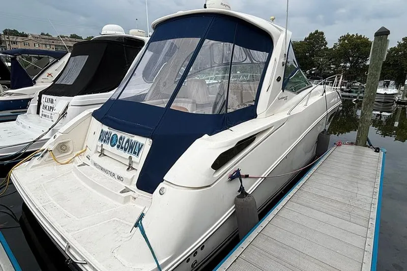  Yacht Photos Pics 2011 Sea Ray 370 Sundancer docked at marina, featuring blue canopy and white hull.