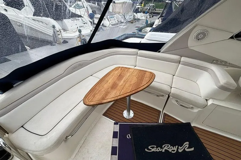  Yacht Photos Pics Luxurious 2011 Sea Ray 370 Sundancer interior with elegant seating and wooden table.