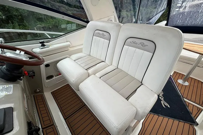  Yacht Photos Pics 2011 Sea Ray 370 Sundancer helm with dual white seats and wooden flooring.