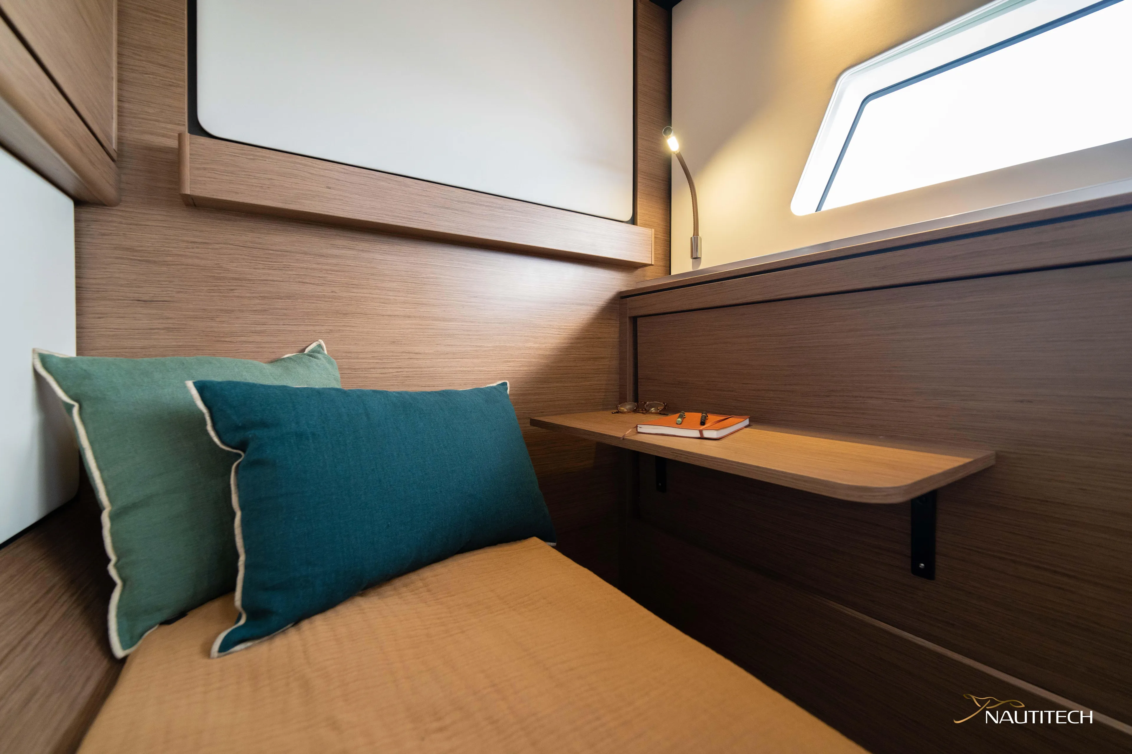 Nautitech 48 Open - Available For 2026 Delivery! Yacht Photos Pics Cozy cabin interior of Nautitech 48 Open (2025) yacht, featuring modern wood finish and soft lighting.