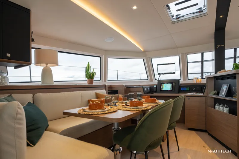 Nautitech 48 Open - Available For 2026 Delivery! Yacht Photos Pics Luxurious interior of Nautitech 48 Open (2025) yacht, featuring elegant dining area and modern navigation equipment.