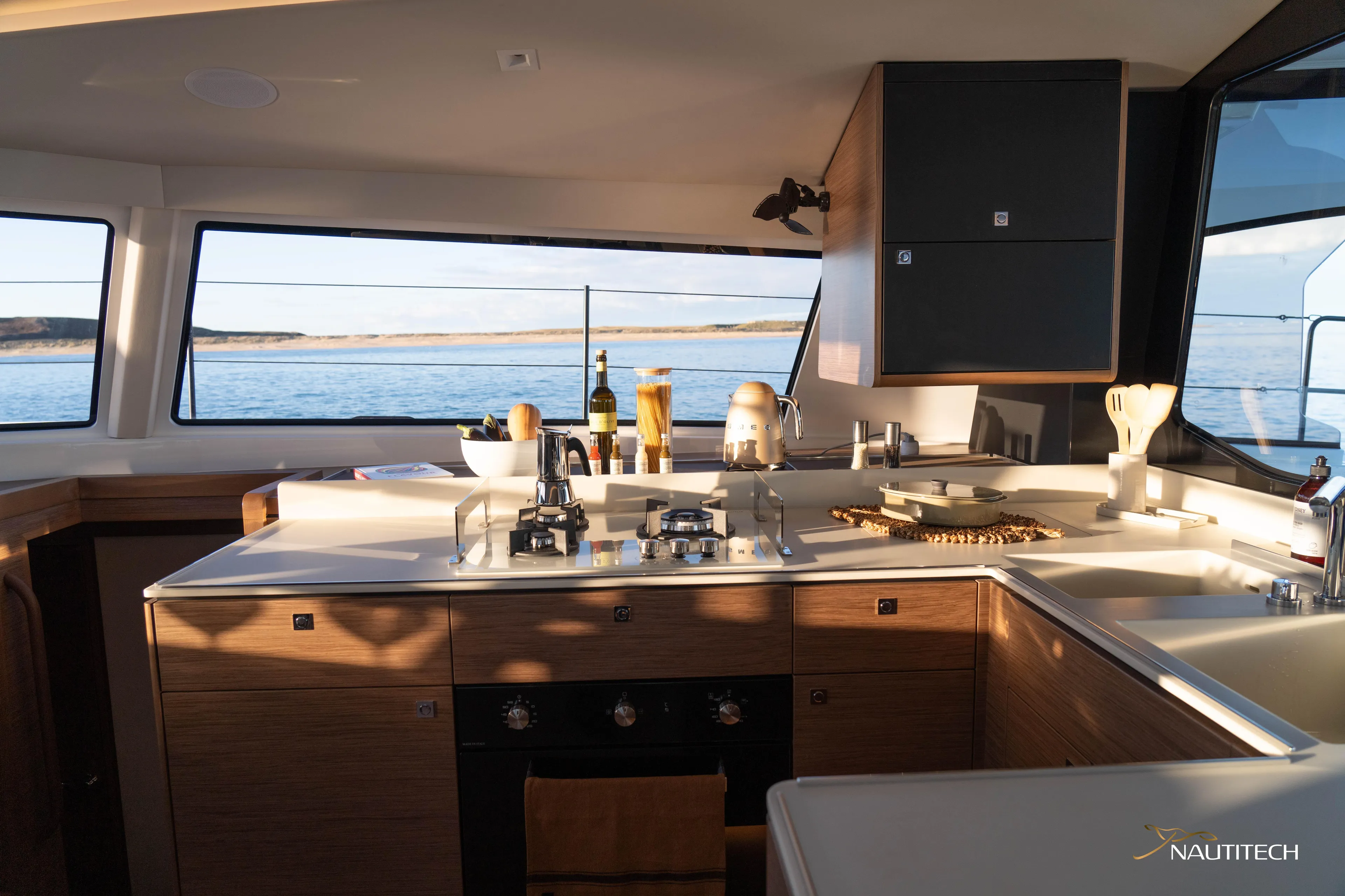 Nautitech 48 Open - Available For 2026 Delivery! Yacht Photos Pics Modern kitchen interior of Nautitech 48 Open (2025) yacht, featuring sleek design and ocean view.