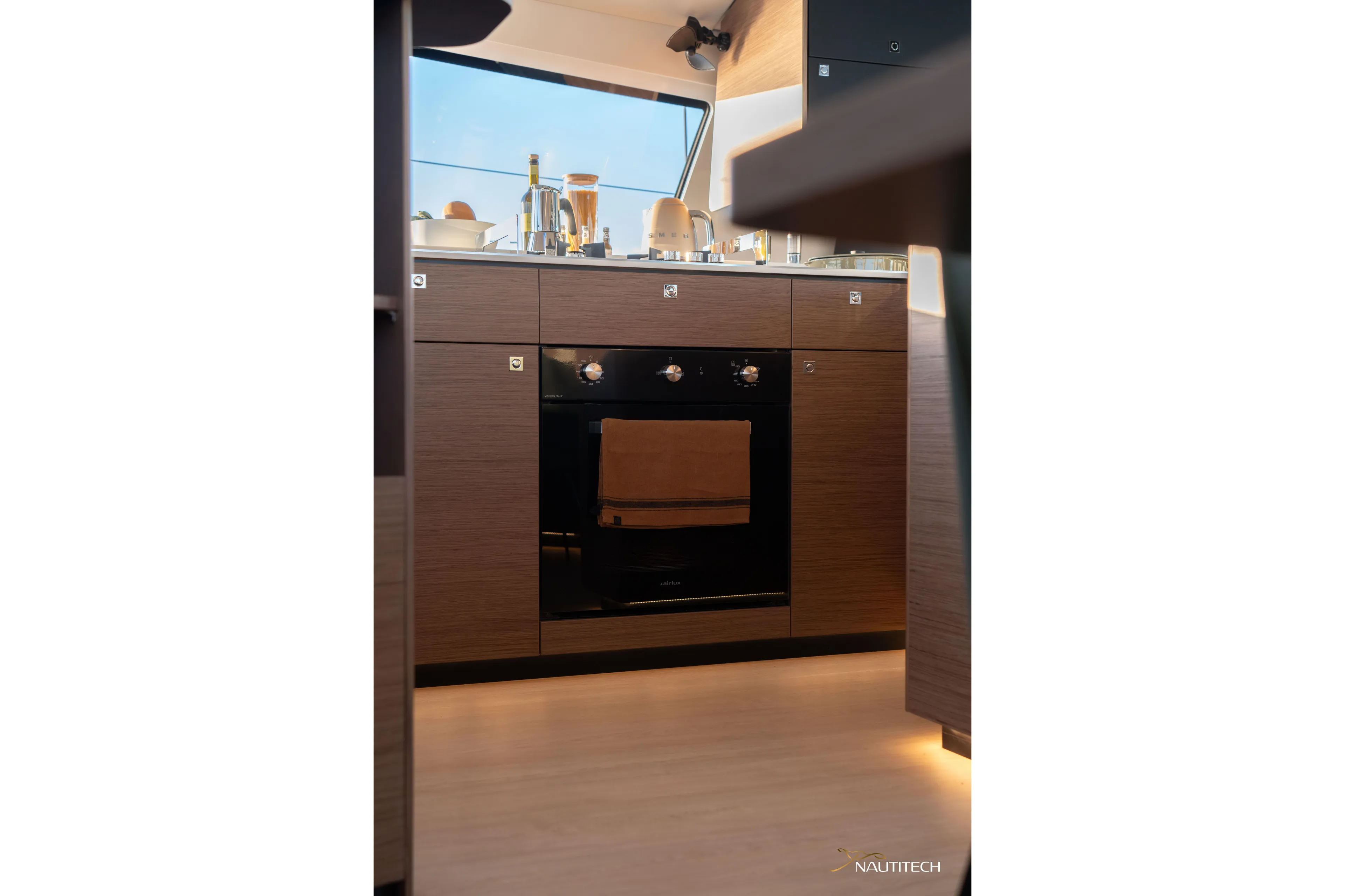 Nautitech 48 Open - Available For 2026 Delivery! Yacht Photos Pics Modern kitchen interior of Nautitech 48 Open (2025) yacht, featuring sleek cabinetry and appliances.
