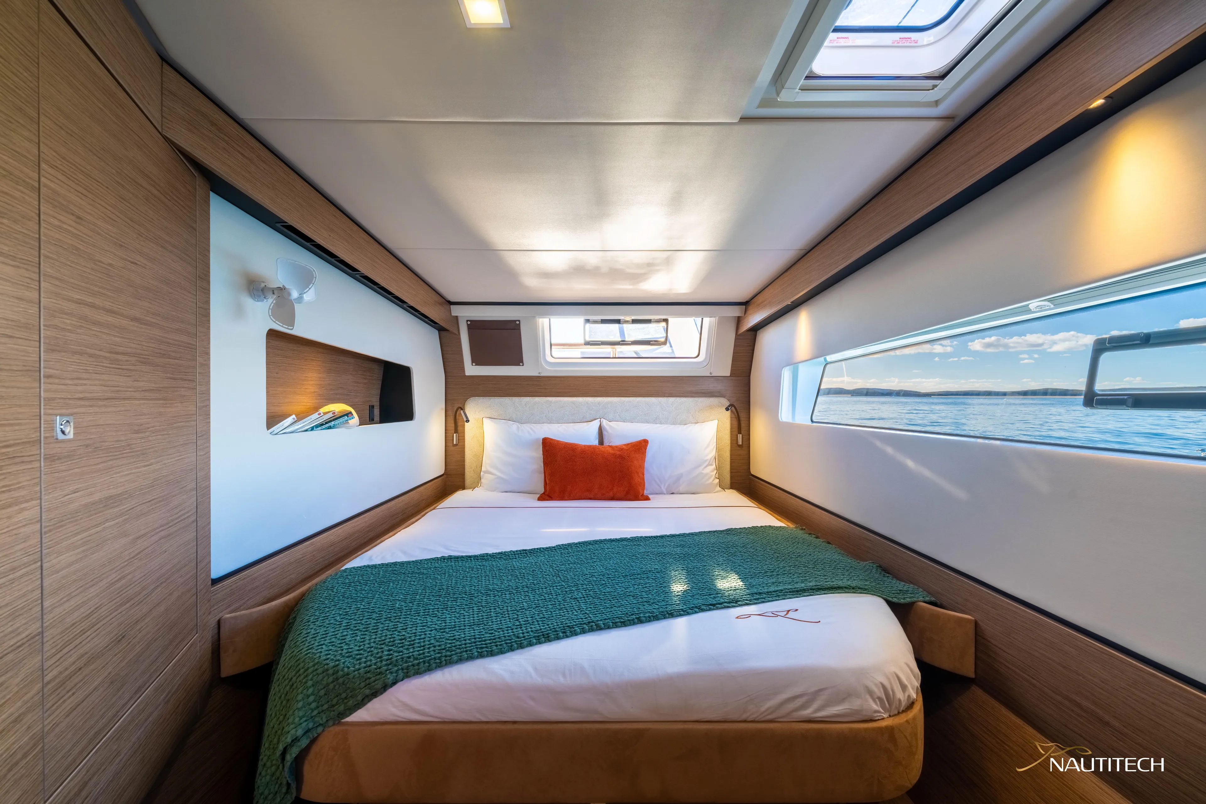 Nautitech 48 Open - Available For 2026 Delivery! Yacht Photos Pics Luxurious cabin interior of Nautitech 48 Open 2026 yacht, featuring a cozy bed and ocean view.