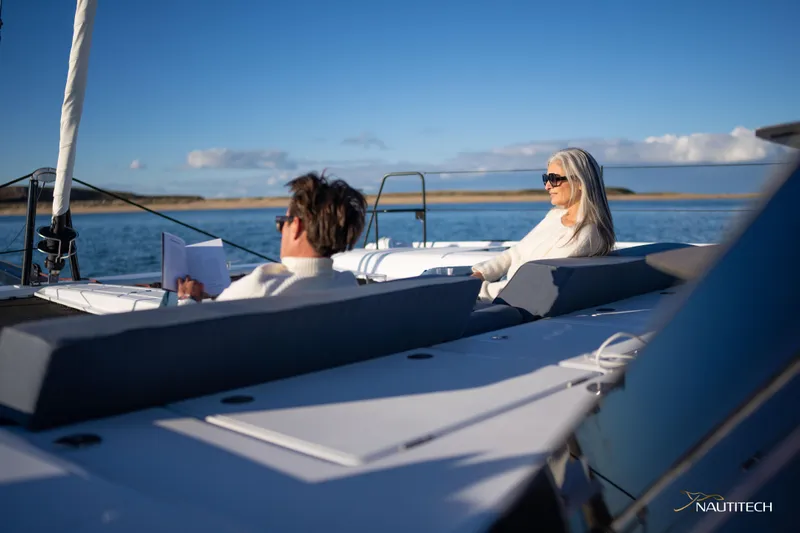 Nautitech 48 Open - Available For 2026 Delivery! Yacht Photos Pics Couple relaxing on Nautitech 48 Open yacht, enjoying sunny day at sea.