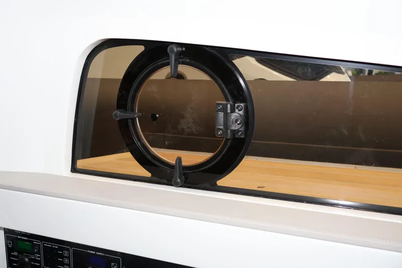  Yacht Photos Pics Round window on 2026 SACS 13 boat interior, featuring sleek design and control panel.