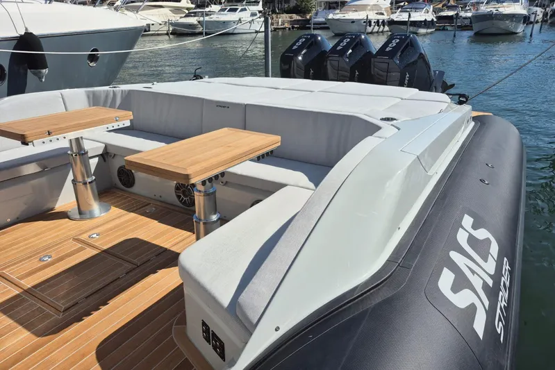  Yacht Photos Pics Luxury SACS 13 boat, 2026 model, featuring sleek design and comfortable seating at a marina.