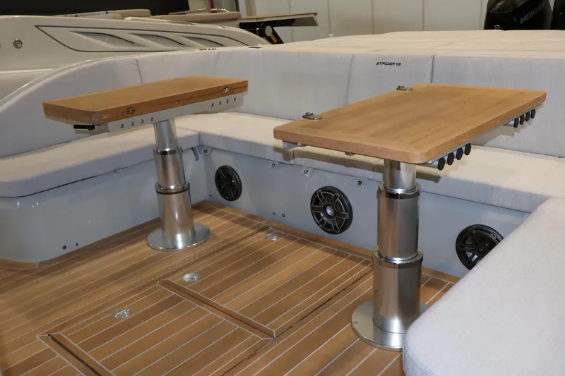  Yacht Photos Pics Luxurious interior of 2026 SACS 13 boat with wooden tables and cushioned seating.
