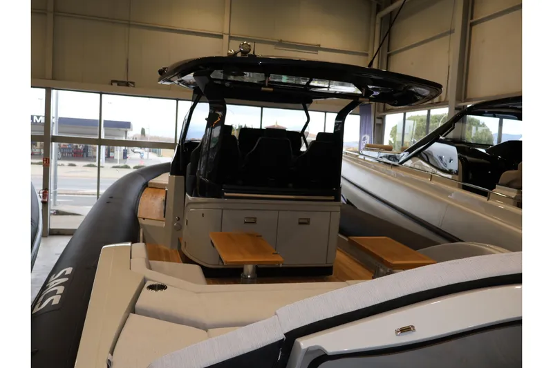 Yacht Photos Pics 2026 SACS 13 boat interior with seating and modern design in showroom.