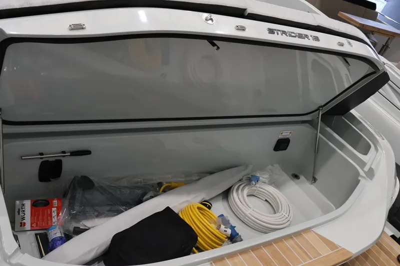  Yacht Photos Pics Open storage compartment of 2026 SACS Strider 13 boat with various equipment.