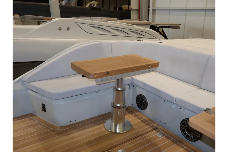  Yacht Photos Pics 2026 SACS 13 boat interior with wooden table and cushioned seating.