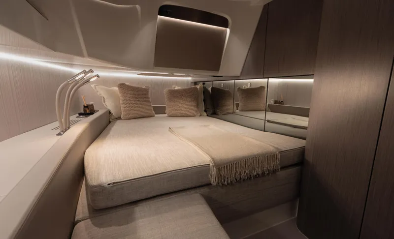  Yacht Photos Pics Luxurious cabin interior of 2026 SACS NEW Strider 13 yacht, featuring elegant bedding and ambient lighting.