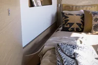 Luxurious Nautitech 48 Open 2026 cabin interior with cozy bedding and modern design elements.