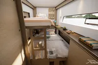 Interior of Nautitech 48 Open 2026, featuring cozy bunk beds and modern design elements.