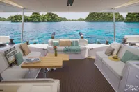 Luxurious Nautitech 48 Open yacht interior with ocean view, featuring elegant seating and a wooden table.