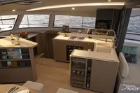 Luxurious interior of Nautitech 48 Open (2025) yacht, featuring modern kitchen and panoramic windows.
