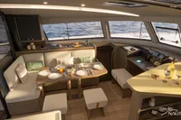 Luxurious interior of Nautitech 48 Open 2026 yacht, featuring elegant dining area and panoramic windows.