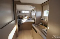 Luxurious cabin interior of Nautitech 48 Open 2026 yacht, featuring modern design and cozy bedding.