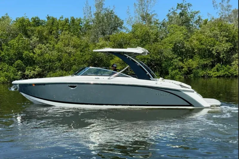  Yacht Photos Pics 2020 Cobalt R30 boat cruising on a calm river with lush greenery.