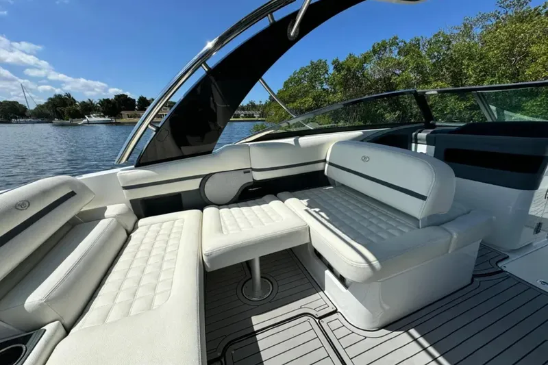  Yacht Photos Pics 2020 Cobalt R30 boat interior with white seating, on a sunny day by the water.