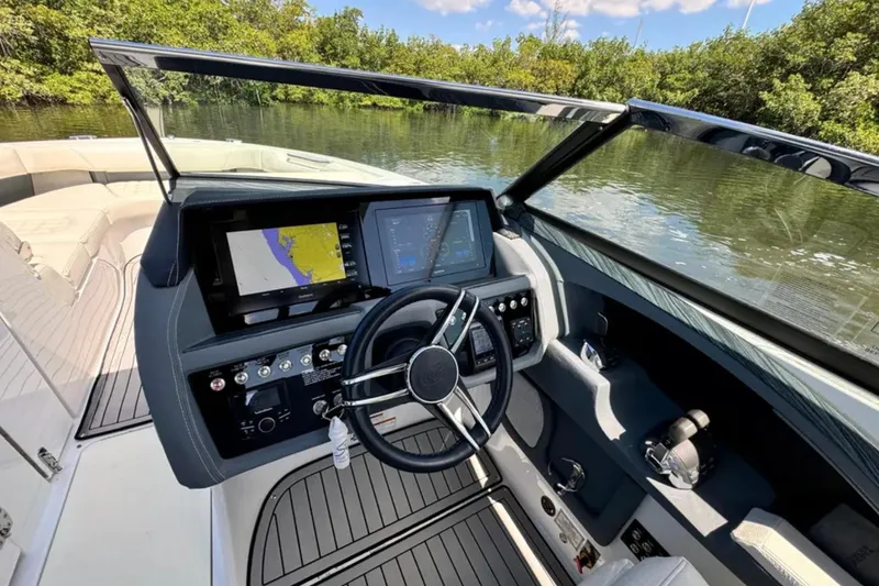  Yacht Photos Pics 2020 Cobalt R30 boat dashboard with navigation screens and steering wheel.