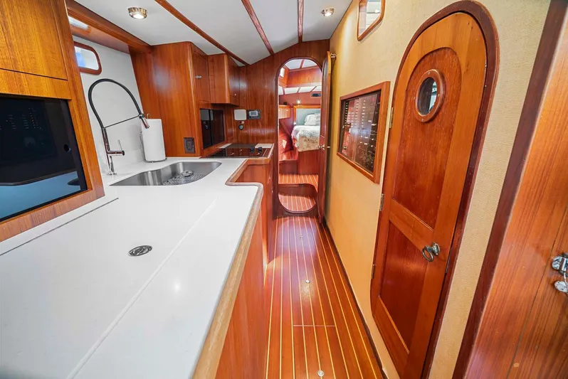 Best Revenge Yacht Photos Pics Luxurious 1981 Pearson 530 yacht interior with wooden finishes and modern kitchen amenities.