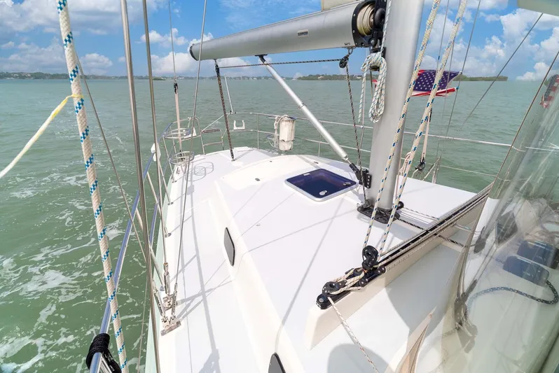 Best Revenge Yacht Photos Pics 1981 Pearson 530 sailboat on calm waters under a clear blue sky.