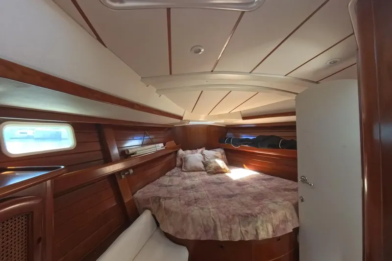 Prime Directive Yacht Photos Pics Cozy cabin interior of 1999 Beneteau Oceanis 461 sailboat with wooden finish.