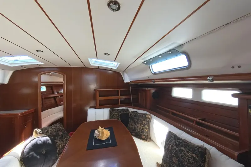 Prime Directive Yacht Photos Pics Interior of 1999 Beneteau Oceanis 461 yacht with elegant wood finish and plush seating.