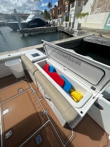 No Name Yacht Photos Pics 2019 Pursuit OS 385 Offshore boat with open storage compartment at marina.