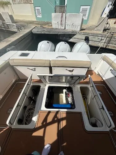 No Name Yacht Photos Pics 2019 Pursuit OS 385 Offshore boat with open storage compartments and triple outboard engines.