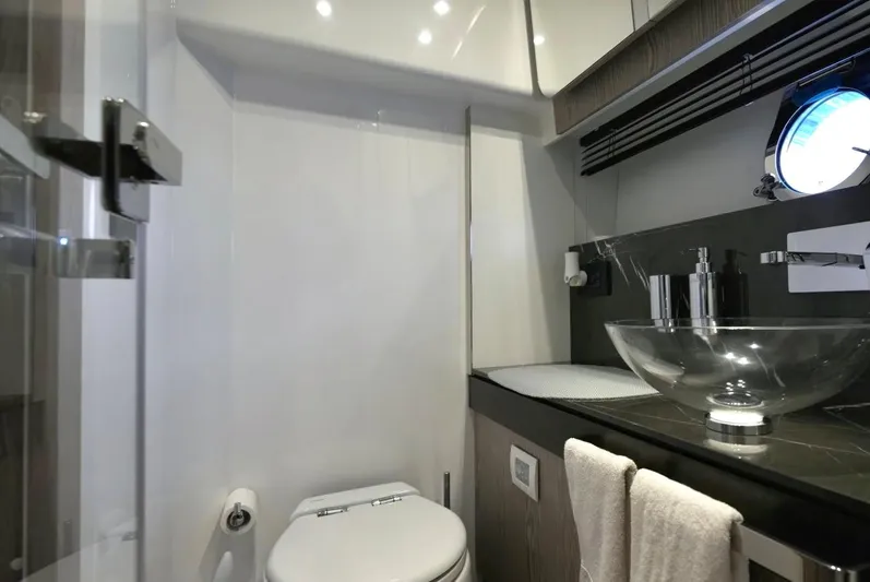  Yacht Photos Pics Luxurious bathroom in 2021 Azimut S6 Sports Fly yacht with modern fixtures and glass sink.