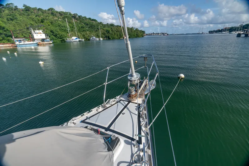 4 Knots Yacht Photos Pics Sailing on a 1990 Hylas 51 yacht in a serene, green bay.