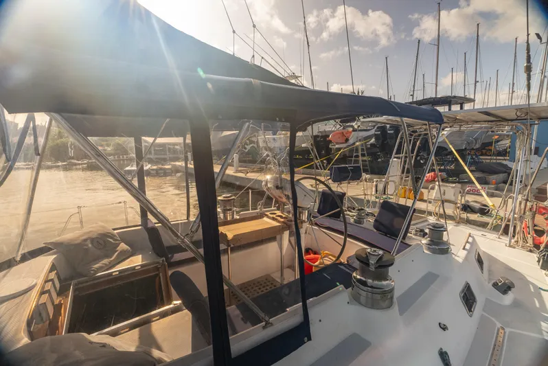 4 Knots Yacht Photos Pics Hylas 51 sailboat from 1990 docked at marina under sunny skies.