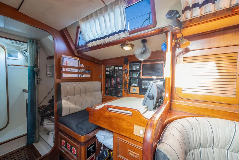 4 Knots Yacht Photos Pics Interior of 1990 Hylas 51 yacht with navigation station and seating area.
