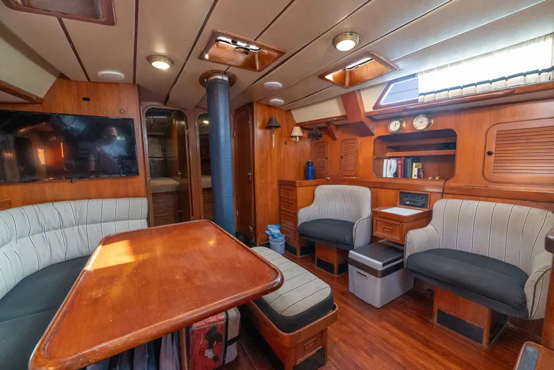 4 Knots Yacht Photos Pics Interior of a 1990 Hylas 51 yacht with wood paneling and comfortable seating.