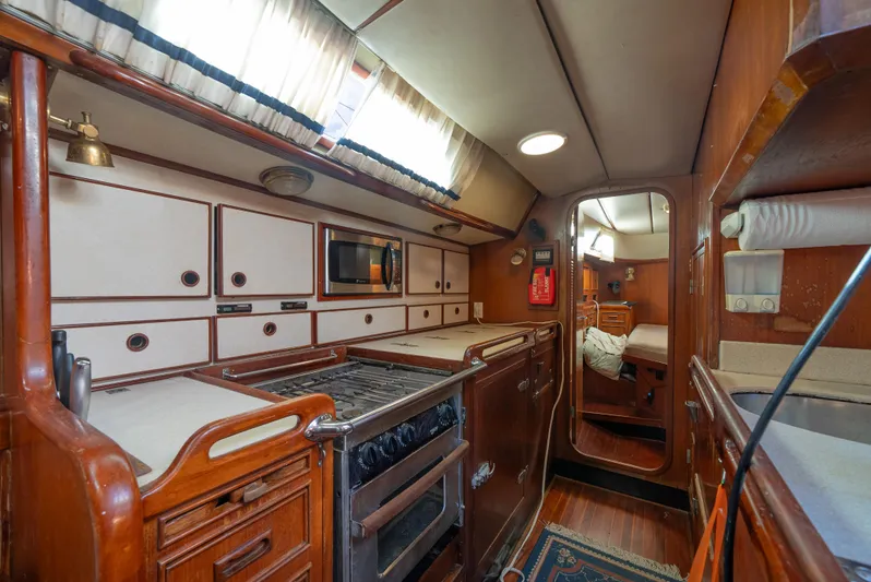4 Knots Yacht Photos Pics Interior of 1990 Hylas 51 yacht, featuring a well-equipped kitchen and cozy cabin space.